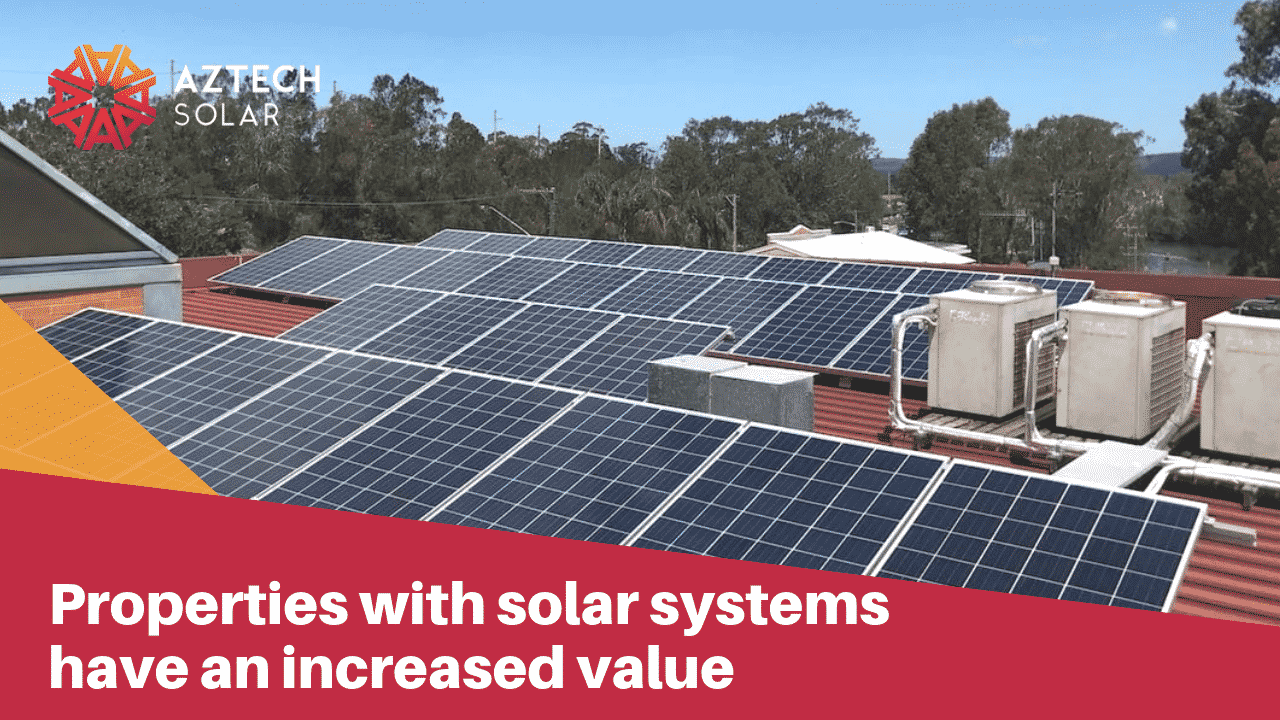 Commercial rooftop solar panels on red building