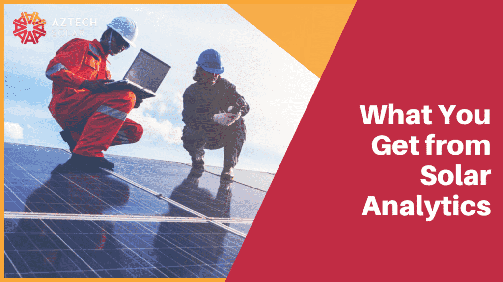 Technicians inspecting solar panels with laptop onsite