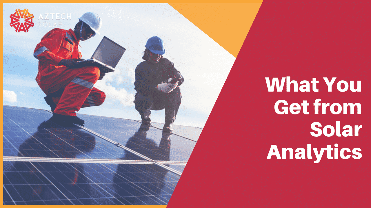 Technicians inspecting solar panels with laptop onsite