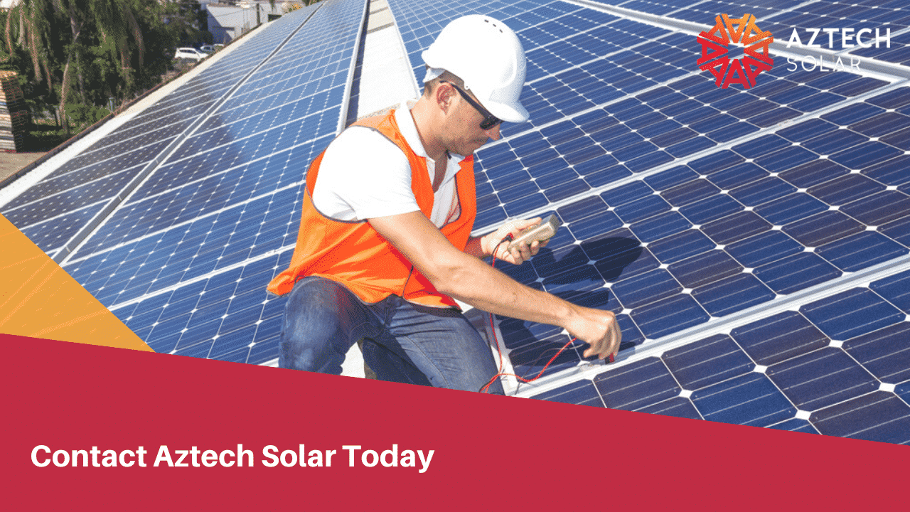 Technician testing rooftop solar panels with multimeter