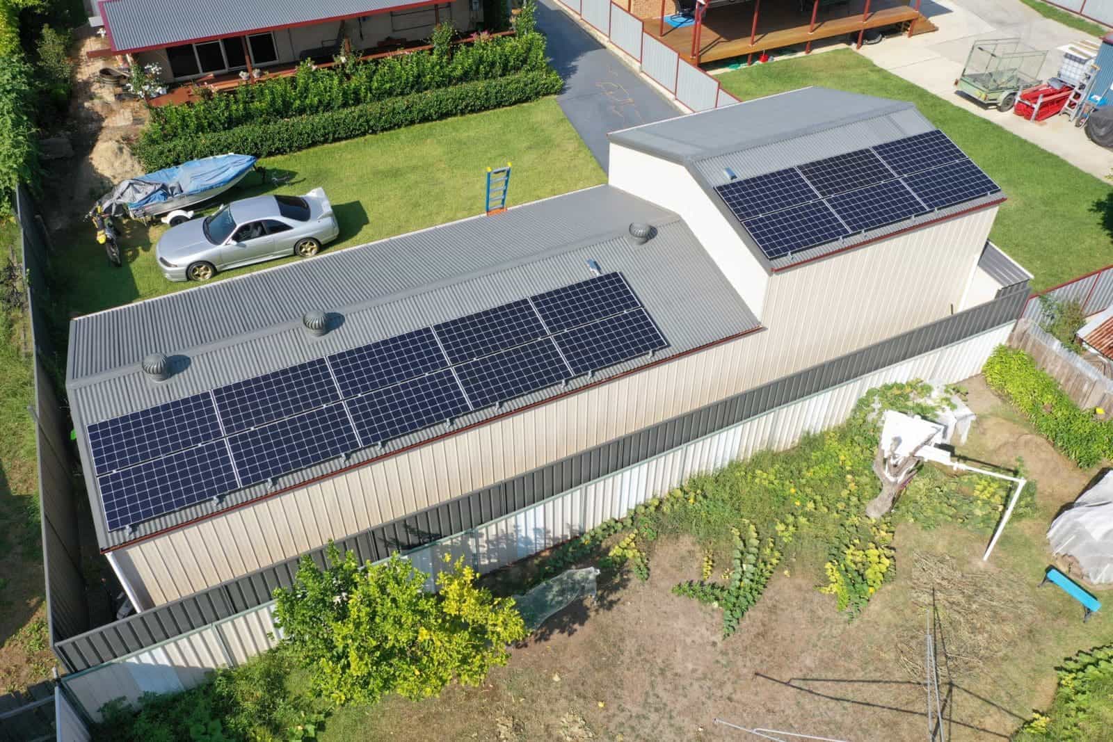 Aerial view of a house with solar panels.