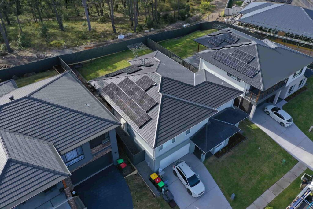Aerial view of houses with solar panels.