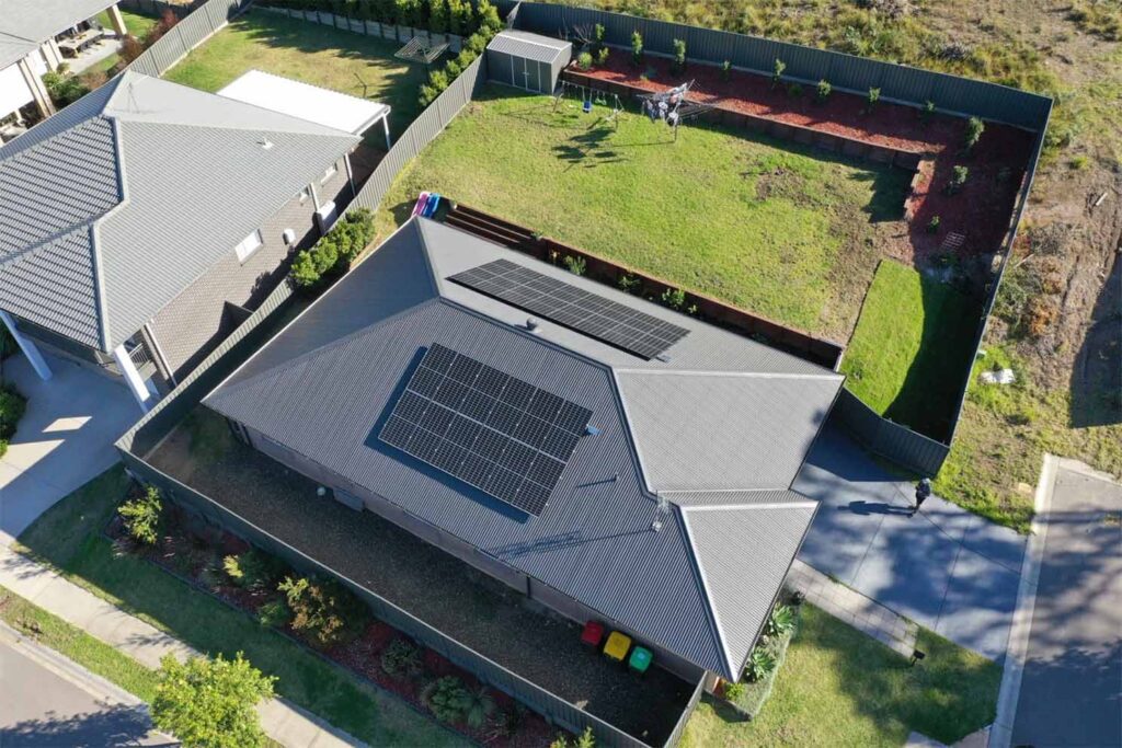 Aerial view of a house with solar panels.