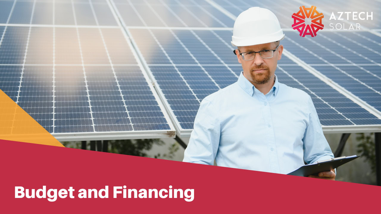 Man in white safety cap holding a paper holder with solar panels on his background