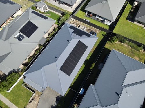 Aerial view of houses with solar panels.