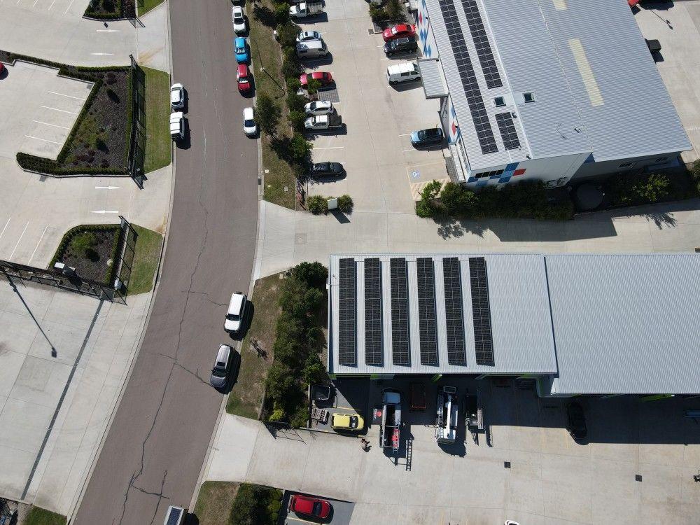 Aerial view of a commercial building with parking.
