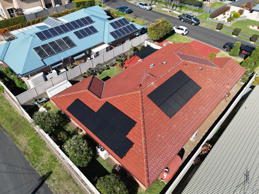 Aerial view of rooftops with solar panels.