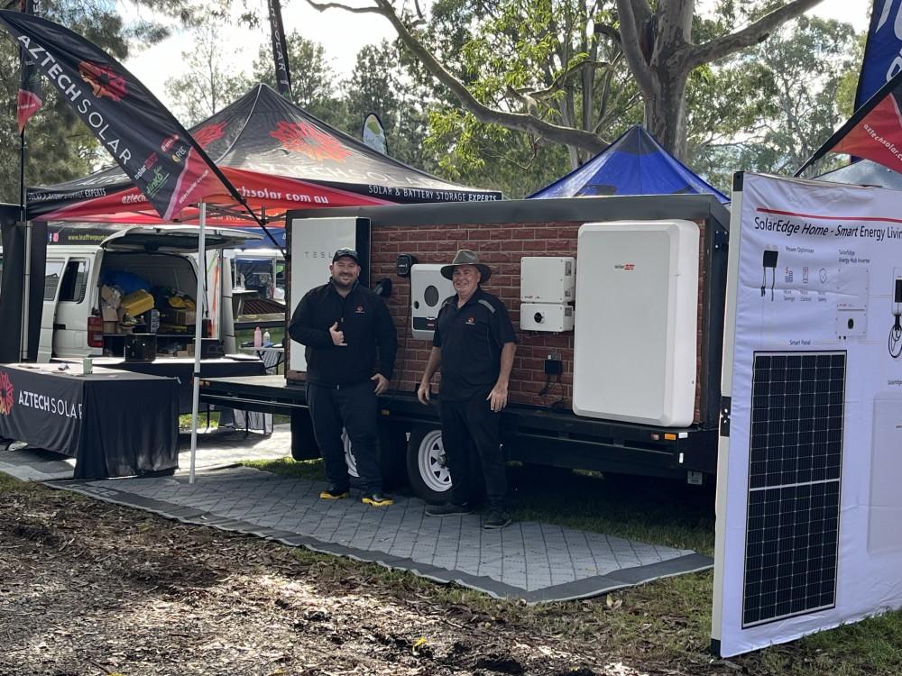 Two men at a solar energy exhibition booth.